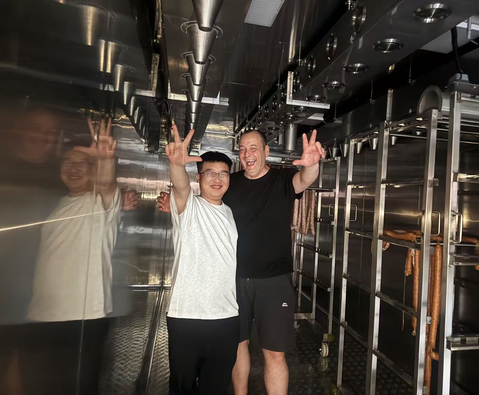 Customer and project engineer inside the completed modular cold-smoking chamber